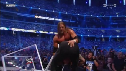 Undertaker reverses a Pedigree and throws Triple H off the Announcer Table