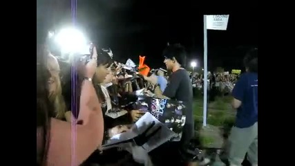 Adam Lambert takes a fan poster after the American Idol concert, Ontario California!!! 