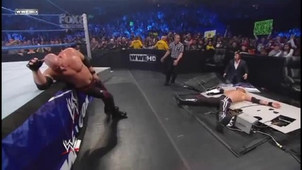Kane Chokeslams Edge through the Announcer Table