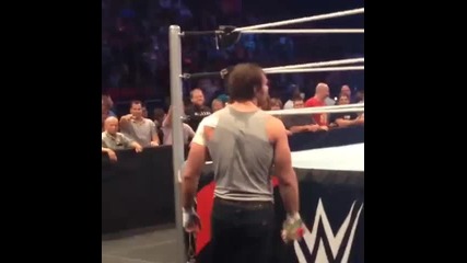 Dean Ambrose gives a rose to security.