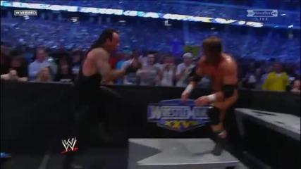 Triple H Spinebusters Undertaker into the Announcer Table