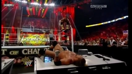Cm Punk elbow drop on Triple H Through a Table