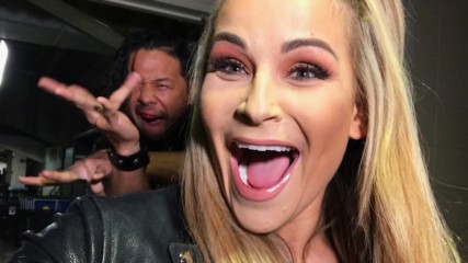 Shinsuke Nakamura photobombs his teammate Natalya en route to WWE Mixed Match Challenge