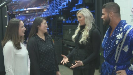 Charlotte Flair and a pair of representatives for Girls Up show Bobby Roode how to "Woo!"