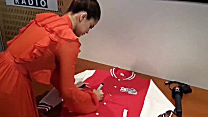 Selena Gomez signing a jacket