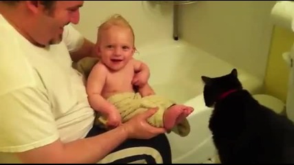 Бебе се радва докато коте му ближе пръстите
