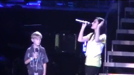 demi lovato on stage with a fan...(i think he is)