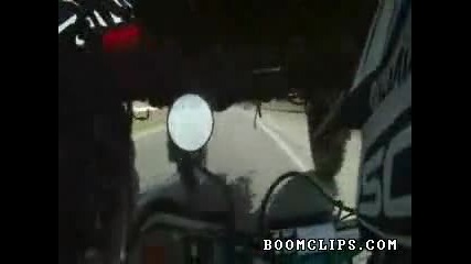 biker drives under tractor video clip 