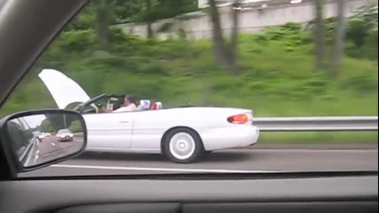 Човек кара кола с вдигнат капак докато чете весник! 
