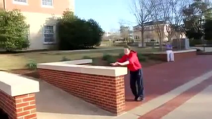 Girl tries to jump over a wall. Fail