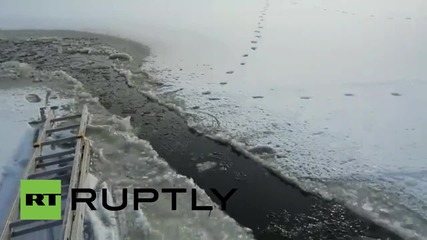 Russia: Rescuers use chainsaw to help free trapped cow from ice