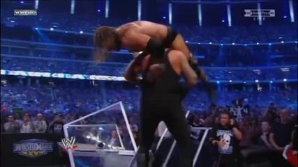 Undertaker reverses a Pedigree and throws Triple H off the Announcer Table