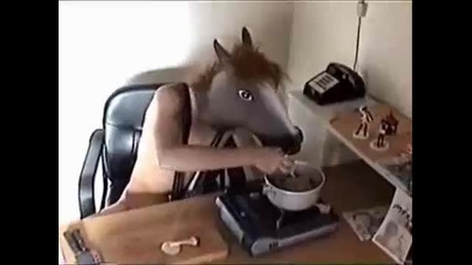 Dancing man wearing a horse mask cooks wild mushrooms 