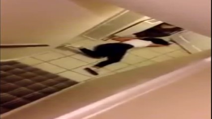 Girl rolls down a staircase