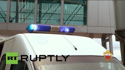 Russia: Polonsky greeted by armed police after touching ground in Moscow