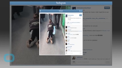 North West Rides Her Frozen Roller Bag Through the Airport