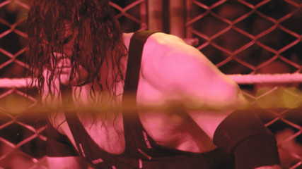 Get up-close and personal for Kane's Steel Cage sneak attack on Roman Reigns