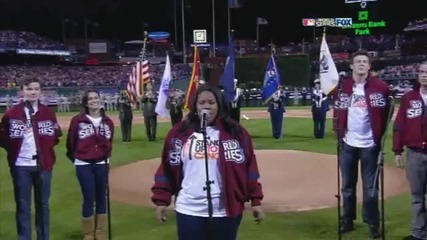 The cast of Glee singing the american national anthem at the World Series 