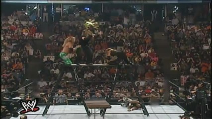 Edge throws Matt Hardy off the Ladder through a Table
