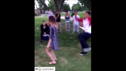 Guy tries to kick water bottle off girls head