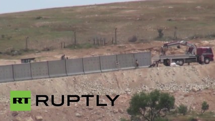 Turkey: Construction workers erect wall along Syrian border