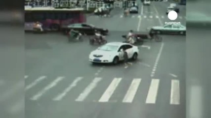 Crowd saves man run over by car in China