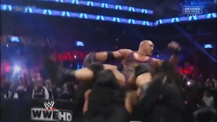 The Shield hits a Triple Powerbomb on Ryback through the announce table