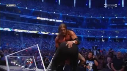 Undertaker reverses a Pedigree and throws Triple H off the Announcer Table