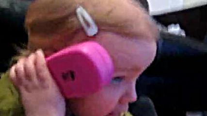 Baby has pretend chat with mummy on her toy phone.via torchbrowser.com
