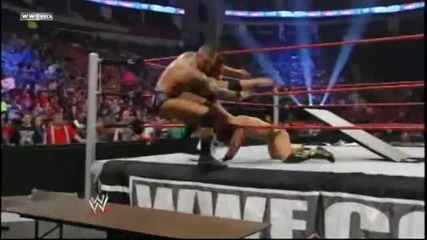 The Miz throws Alex Riley on Randy Orton through a Table
