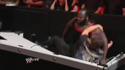 Mark Henry hits a World's Strongest Slam on Jerry Lawler on the announcer table
