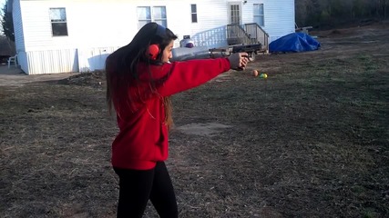 15 year old asian girl. Beasting an M and P 40