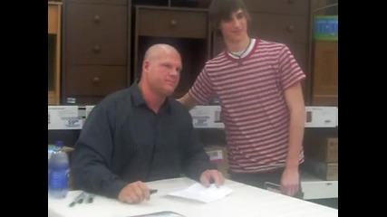Me having Wwes Kane autograph my report card 