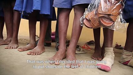 The woman who puts shoes on barefoot students