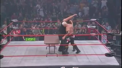 Double Chokeslam on Abyss through a Table