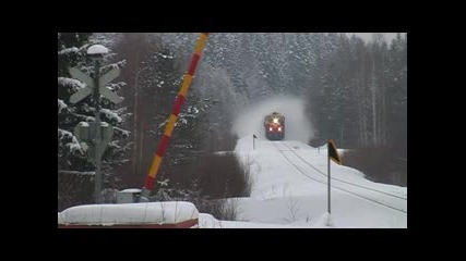 Passenger Train Whirling Snow Into Air