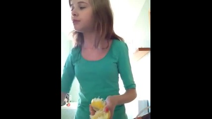 Girl eats lemon (with peel)