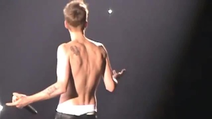 Justin Bieber takes his shirt off while singing Baby