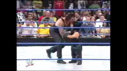 Mini Taker takes a Chokeslam from The Undertaker. Funny.