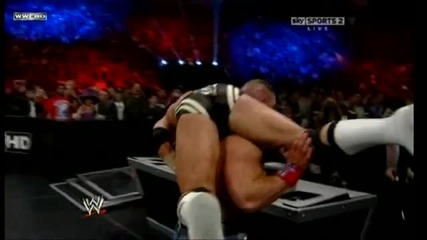 Attitude Adjustment through the announcer table - John Cena