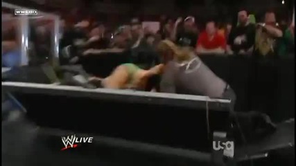 Triple H Pedigrees Ted Dibiase into the announcer table
