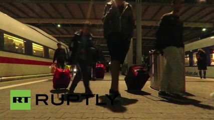 Germany: Exhausted refugees wait for northbound trains in Munich