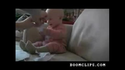 baby laughing hysterically at ripping paper