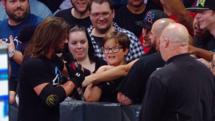 AJ Styles Woos the crowd following Fenomenal Flair's Mixed Match Challenge victory