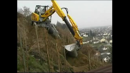 Menzi Muck A91 sideways on a hillside working in a vineyard