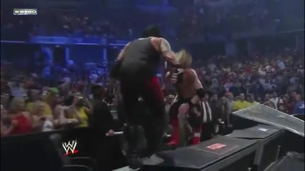 Edge Spears The Undertaker through the Announcer Table