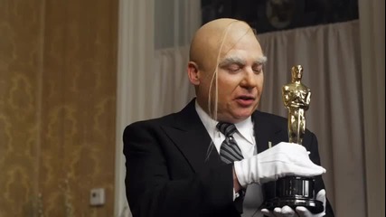 Mike Myers and Kevin Kline offer instruction on the best way to hold an Oscar statuette.