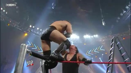Undertaker Chokeslams Curt Hawkins off the Turnbuckle through a Table