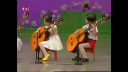 North Korea children playing the guitar. Creepy as hell.