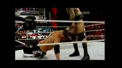 Randy Orton hits a powerbomb on Alex Riley through the table